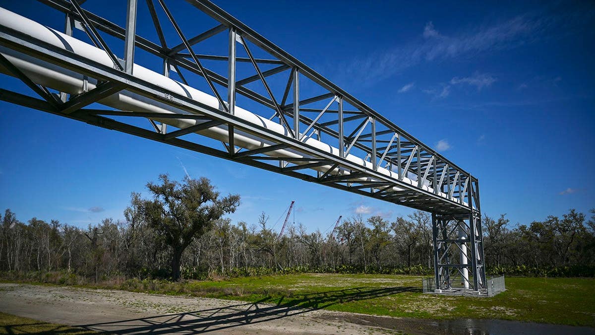 Pipelines raised above levee system at Venture Global's Plaquemines LNG export facility in Port Sulphur Louisiana