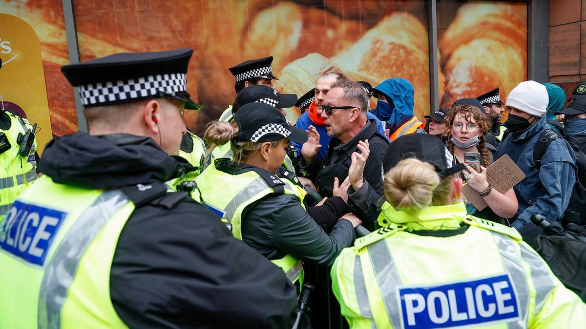 Protesters pushing against police cordon at Buchanan Steps in Glasgow