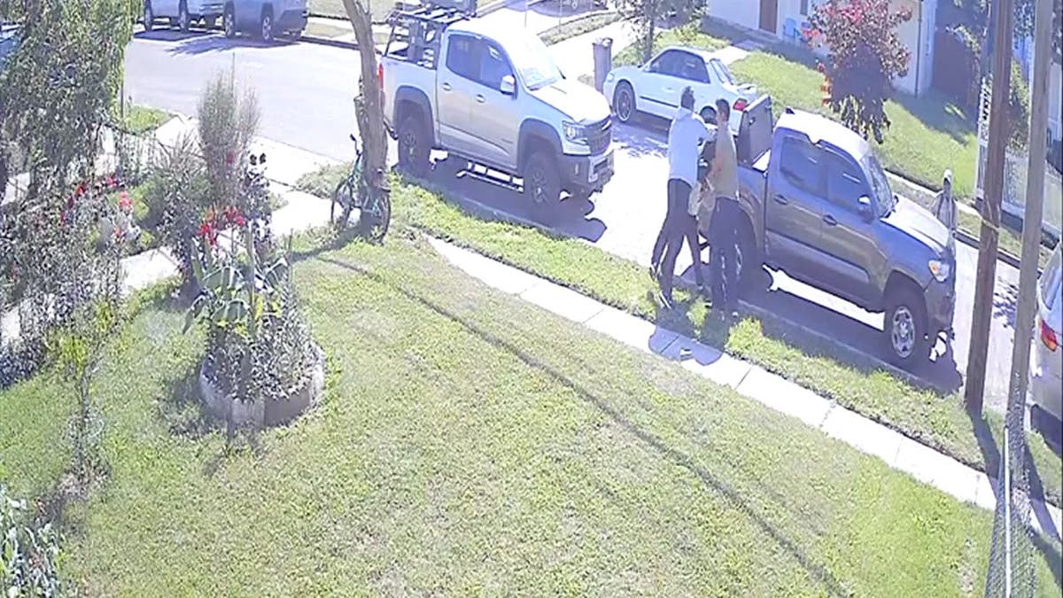 still image of hooded teens allegedly trying to attack a victim