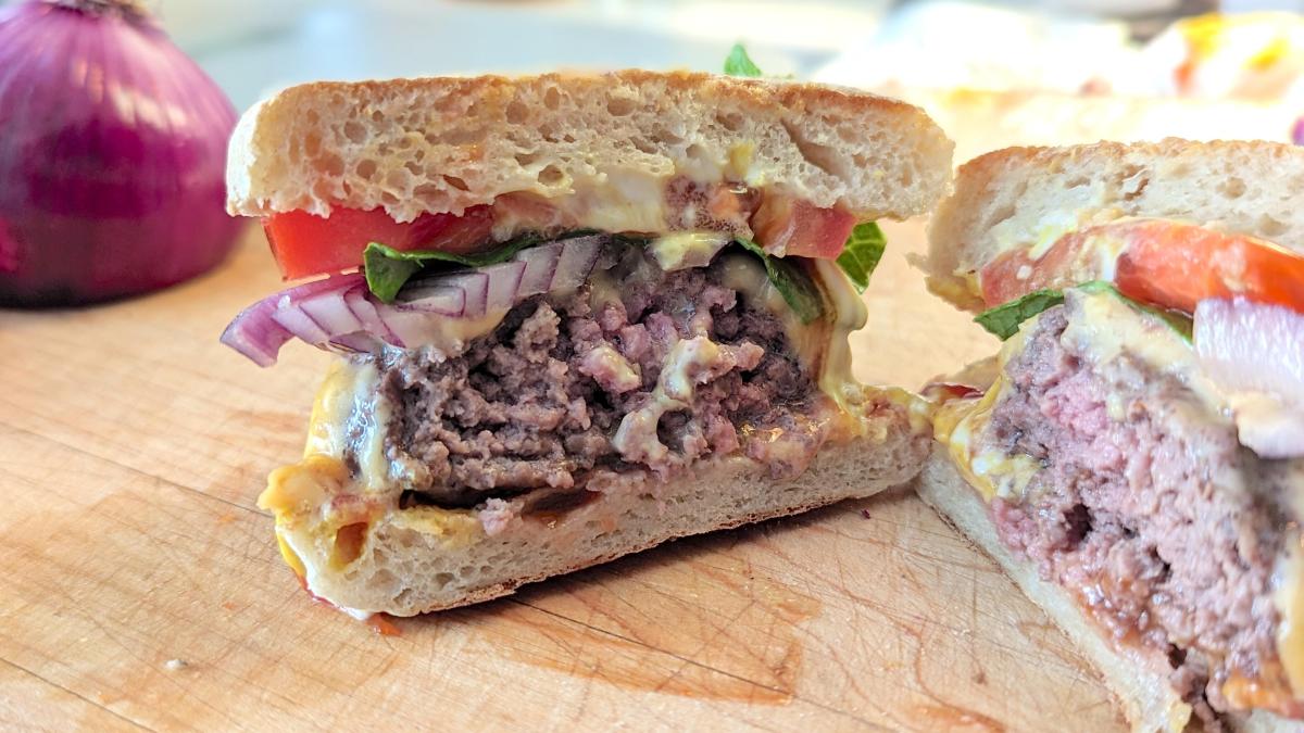 a burger cooked to medium cut in half