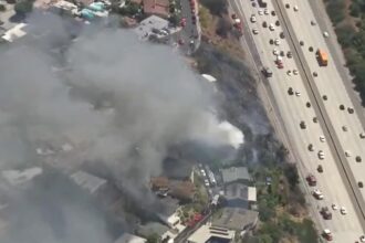 Fast-moving LA wildfire torches home, threatens nearby properties