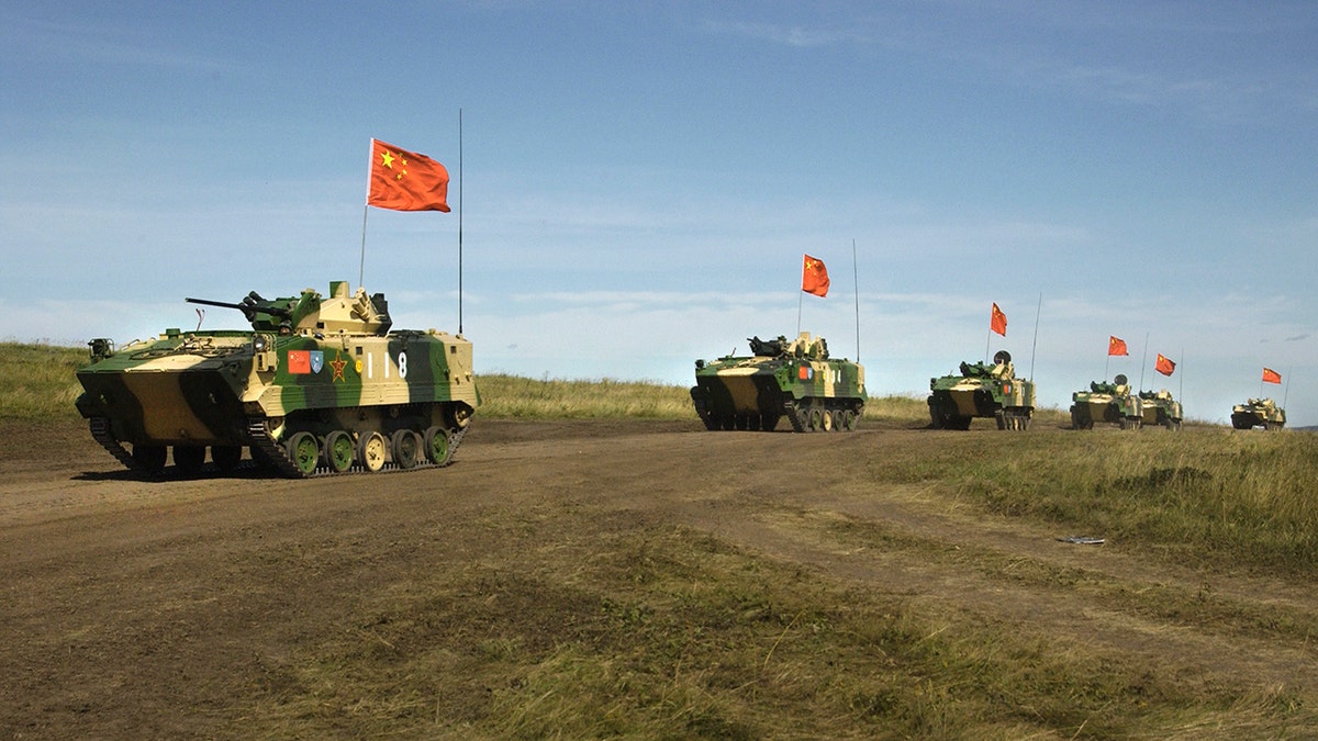 FILE - In this Aug. 13, 2007, file photo, a convoy of Chinese APCs roll by during a rehearsal for a massive joint military exercise by the two former Cold War rivals, the first on Russia's territory in the Chelyabinsk region in Russia's Ural Mountains. Chinese and Russian military forces are engaged in joint exercises through Friday, Aug. 13, 2021, in northwestern China as ties grow between the two autocratic states amid uncertainty over instability in Afghanistan.
