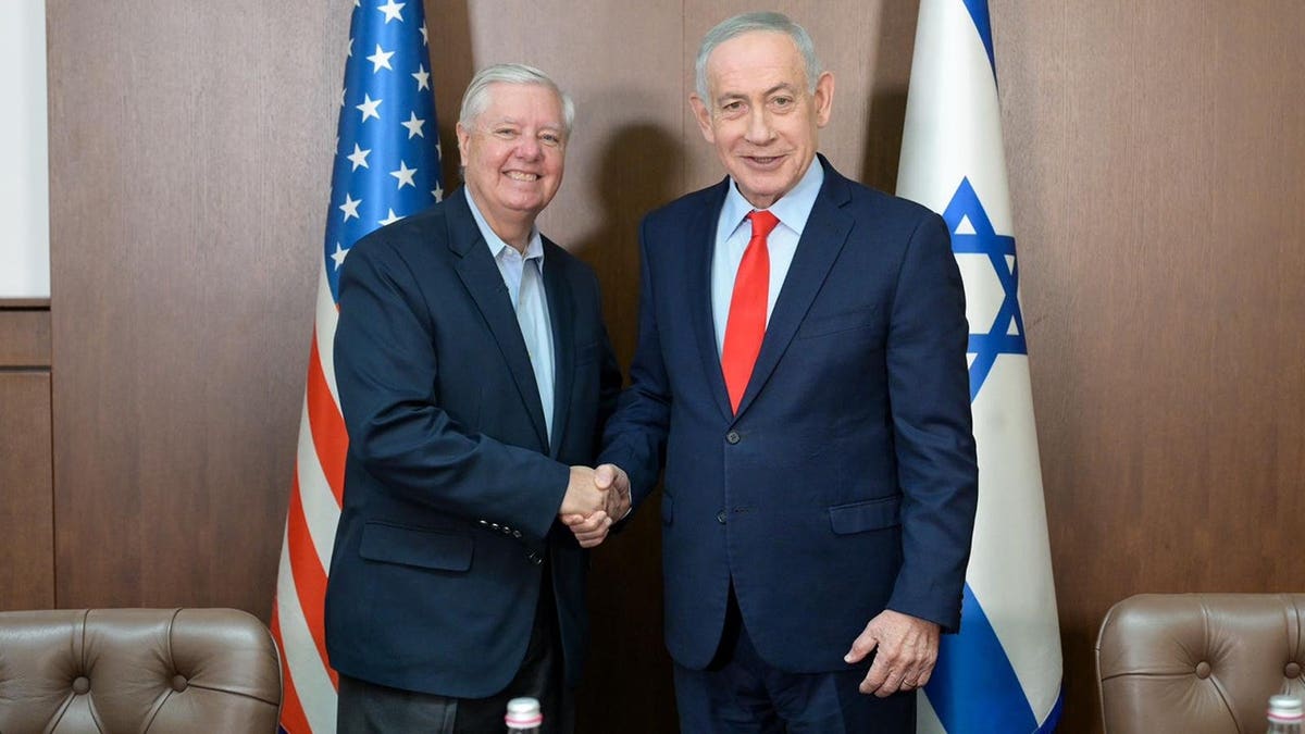 Israel Prime Minister Benjamin Netanyahu shakes hands with Sen. Lindsey Graham