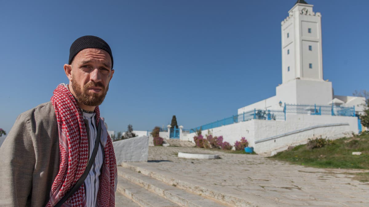Fergie Chambers walks near a mosque in Tunis.