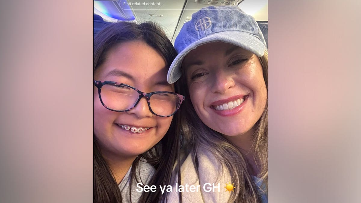 A woman in a monogrammed denim cap smiles cheek to cheek with a young girl wearing glasses and braces inside an airplane cabin, with the overlaid text