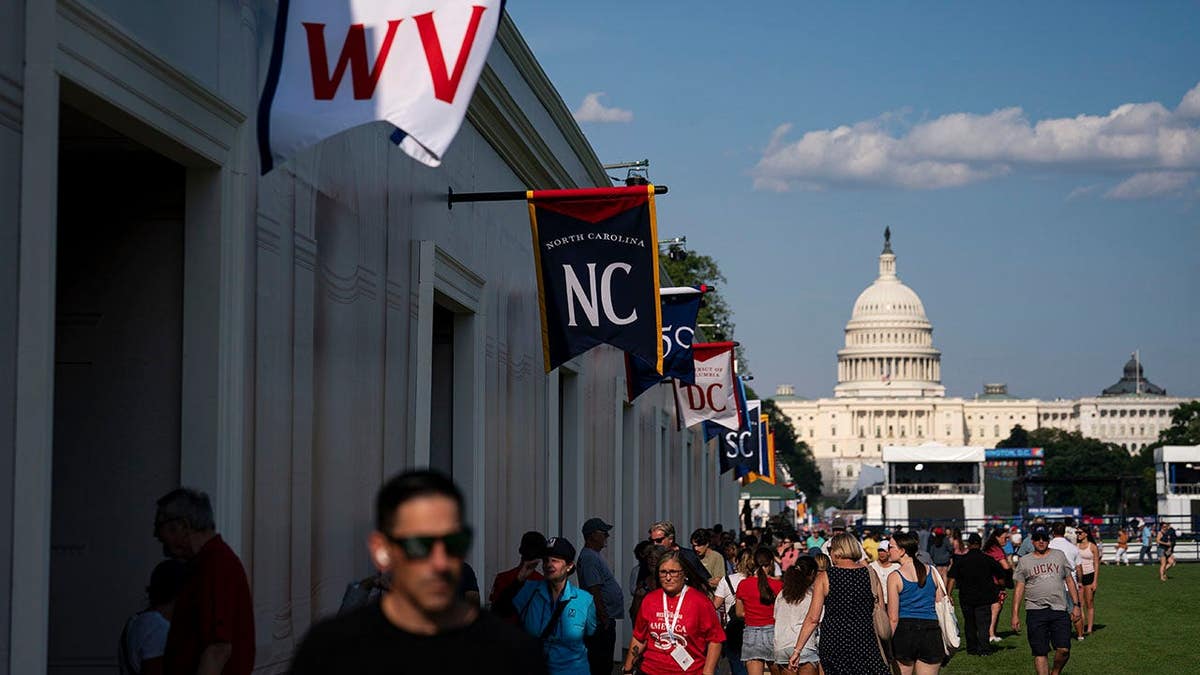 Participants walk past state exhibits at the Great American State Fair