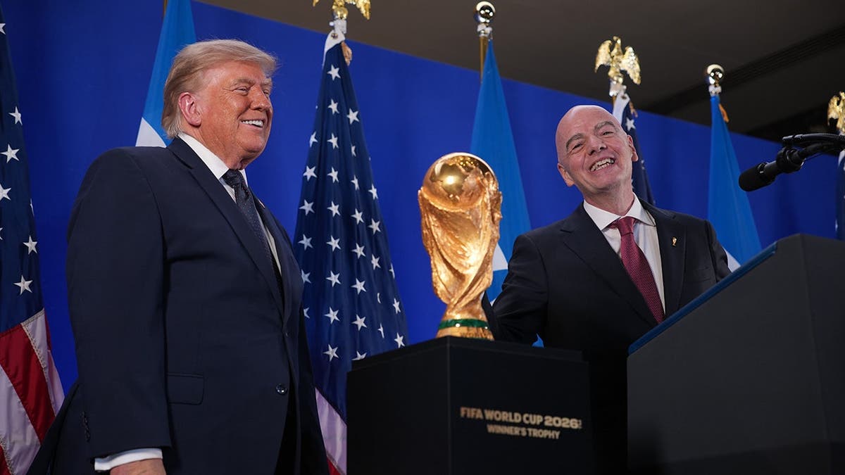Donald Trump speaks beside Gianni Infantino at Trump Tower.