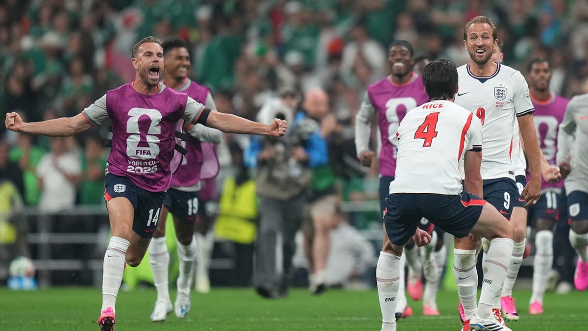 England's Harry Kane and Jordan Henderson celebrate after World Cup round of 16 match against Mexico.