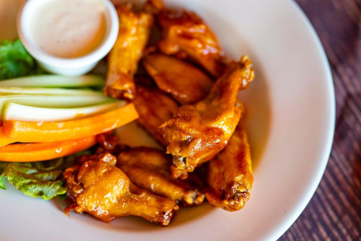 Chicken wing prices are down —but your favorite restaurant may not cut costs