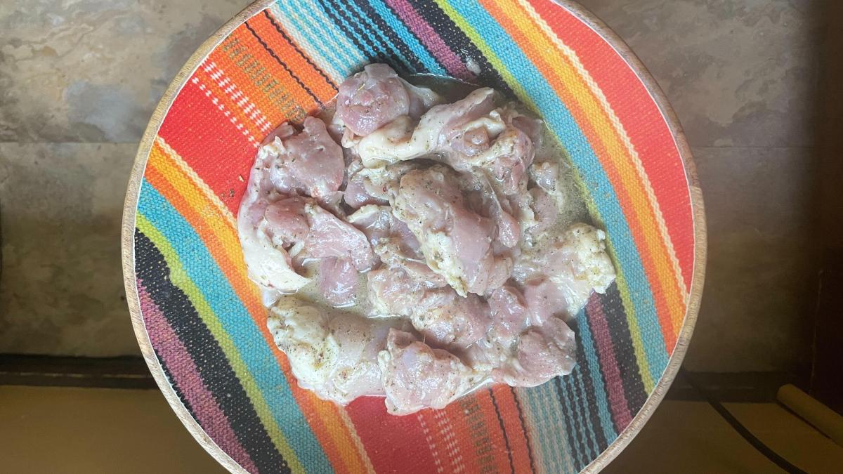 chicken in bowl being marinated