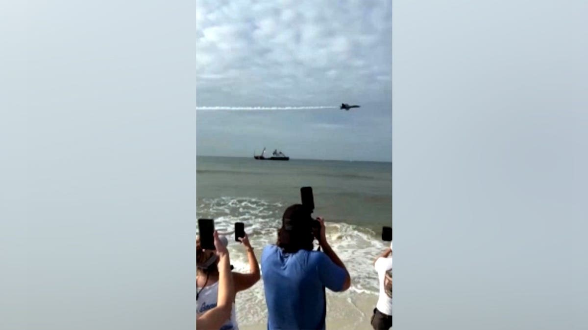 People photograph Blue Angels jets over Pensacola Beach.
