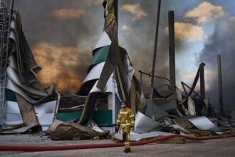 Russian drone strikes hit Ukraine as warehouses burn