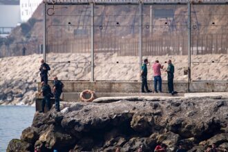 Spain mobilises troops as thousands swim across border from Morocco