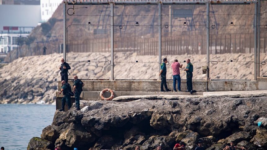 Spain mobilises troops as thousands swim across border from Morocco