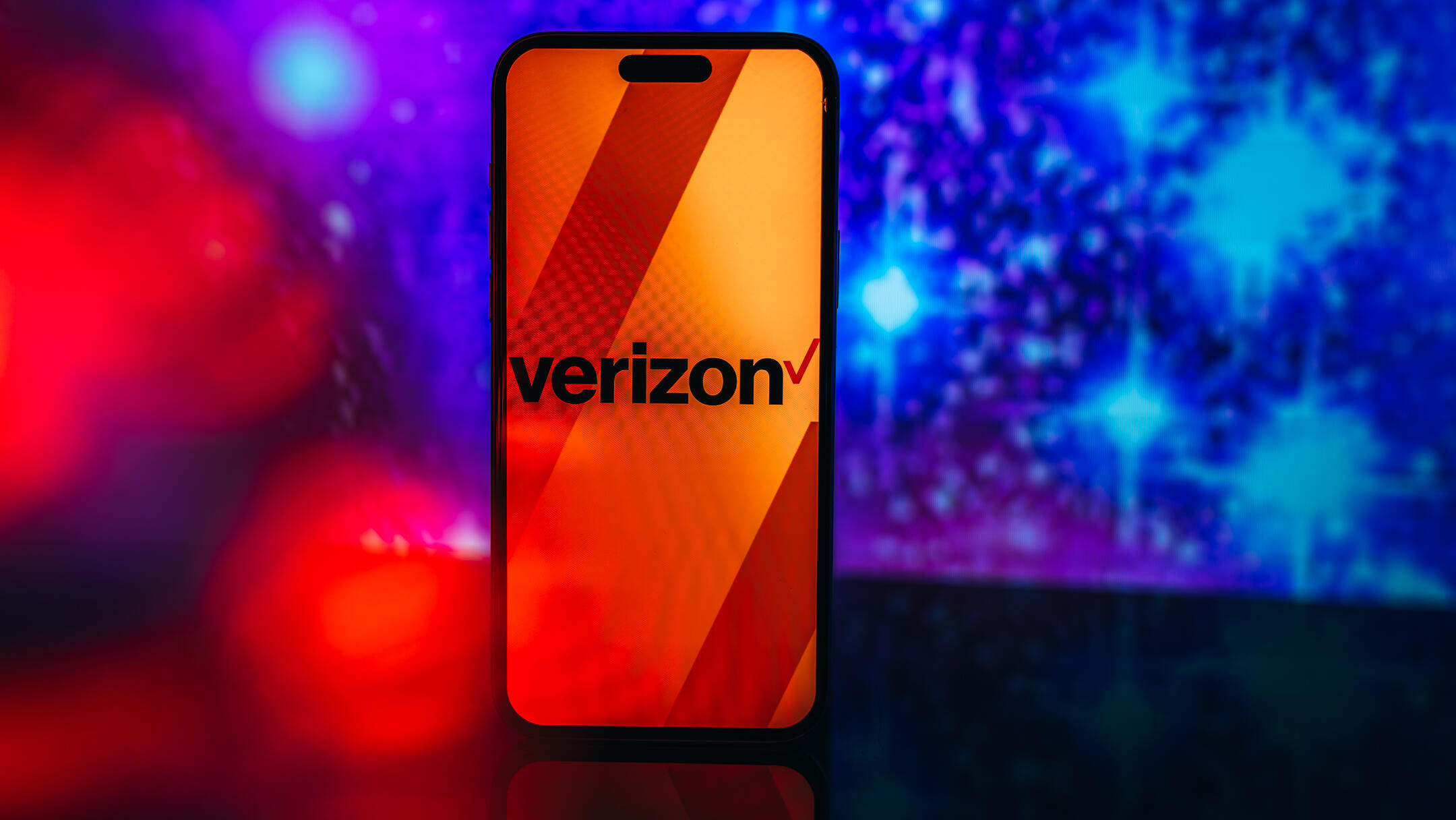 mobile carrier logo on phone screen against blue backdrop