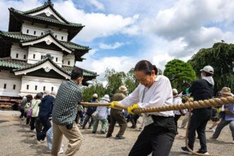 Hundreds of volunteers pull 360-tonne historic Japanese castle back into place by hand