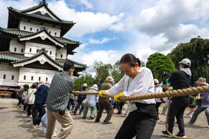 Hundreds of volunteers pull 360-tonne historic Japanese castle back into place by hand