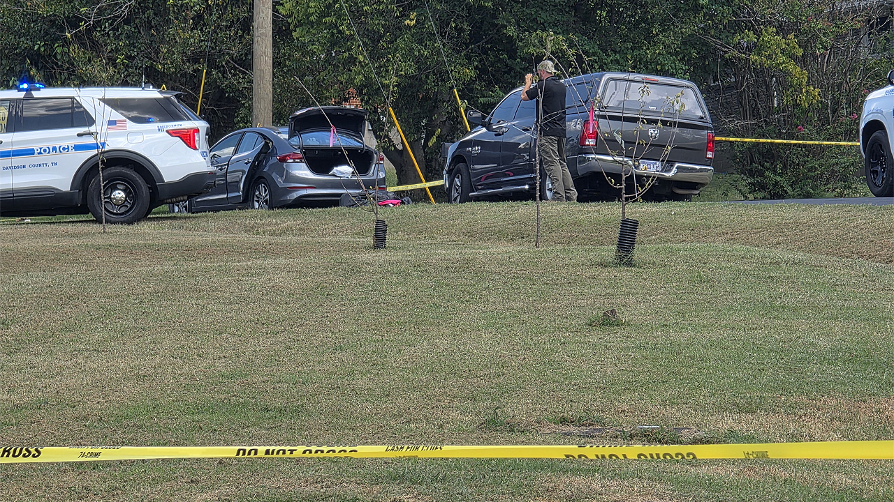 Police fatally shoot sword-wielding man after woman found trapped in car, officials say