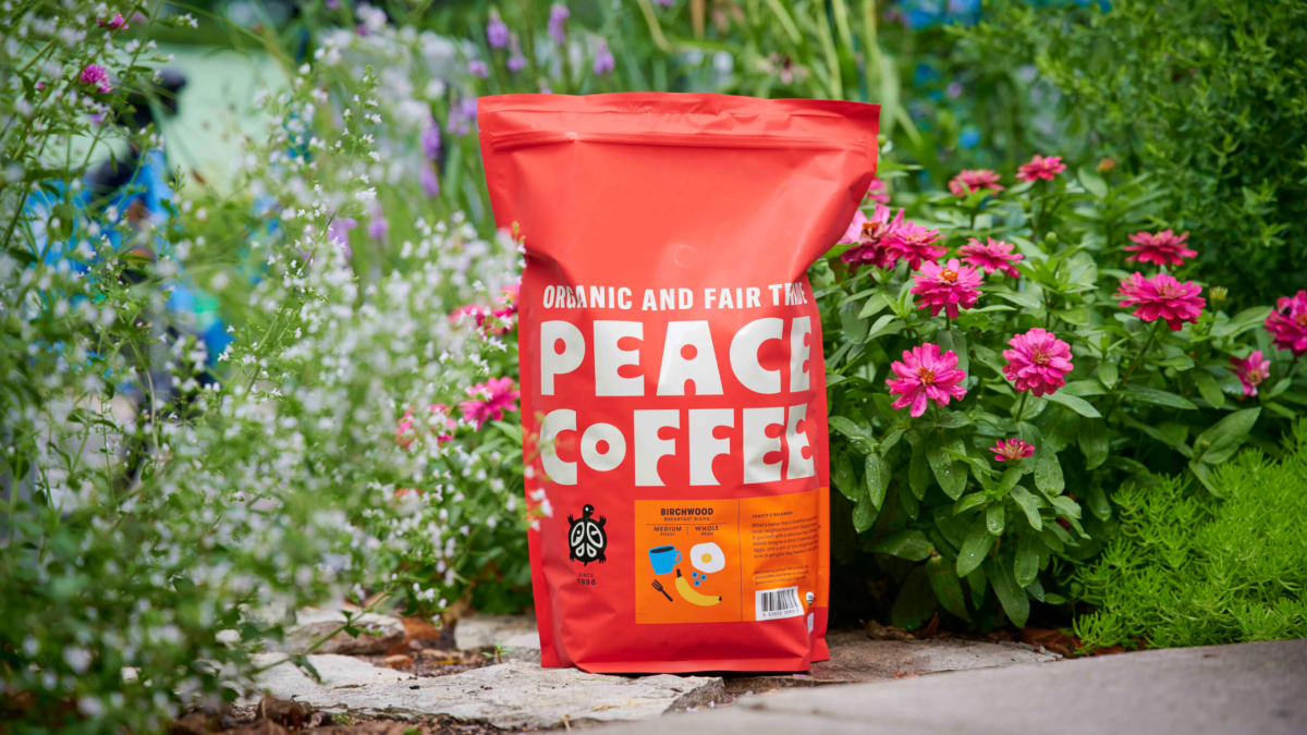bag of organic coffee in front of flowers