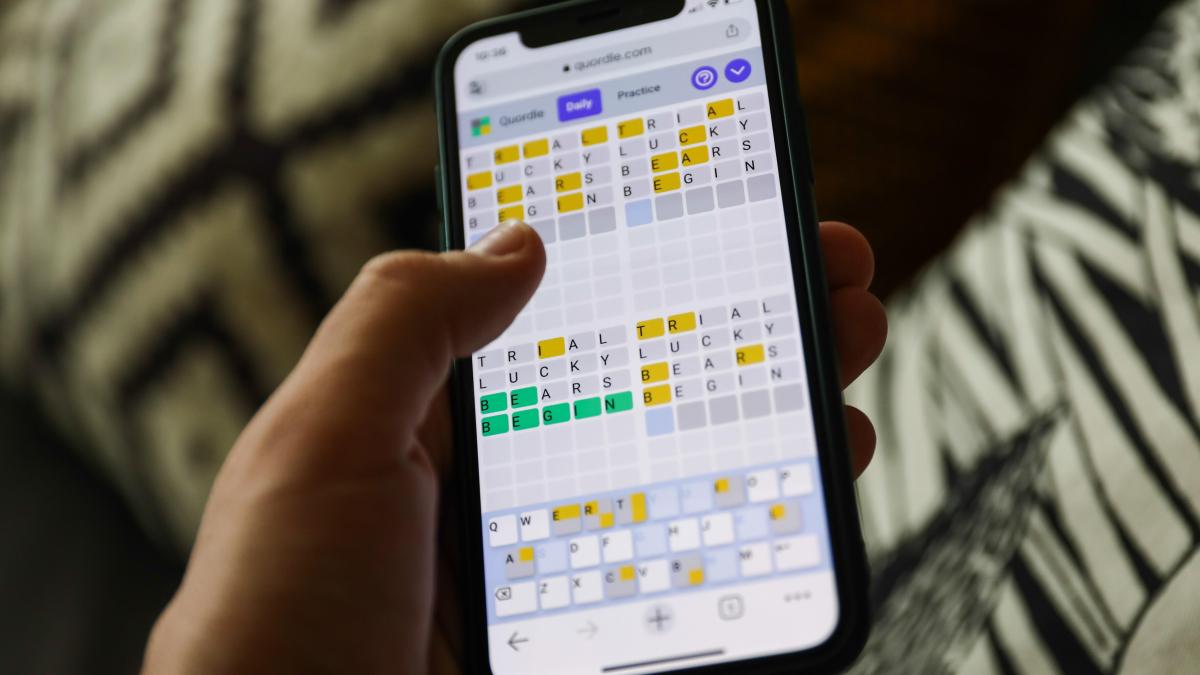 A person playing Quordle on their phone.