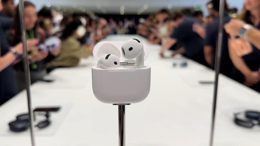 The AirPods 4 shown on a pedestal at Apple's iPhone 16 event.