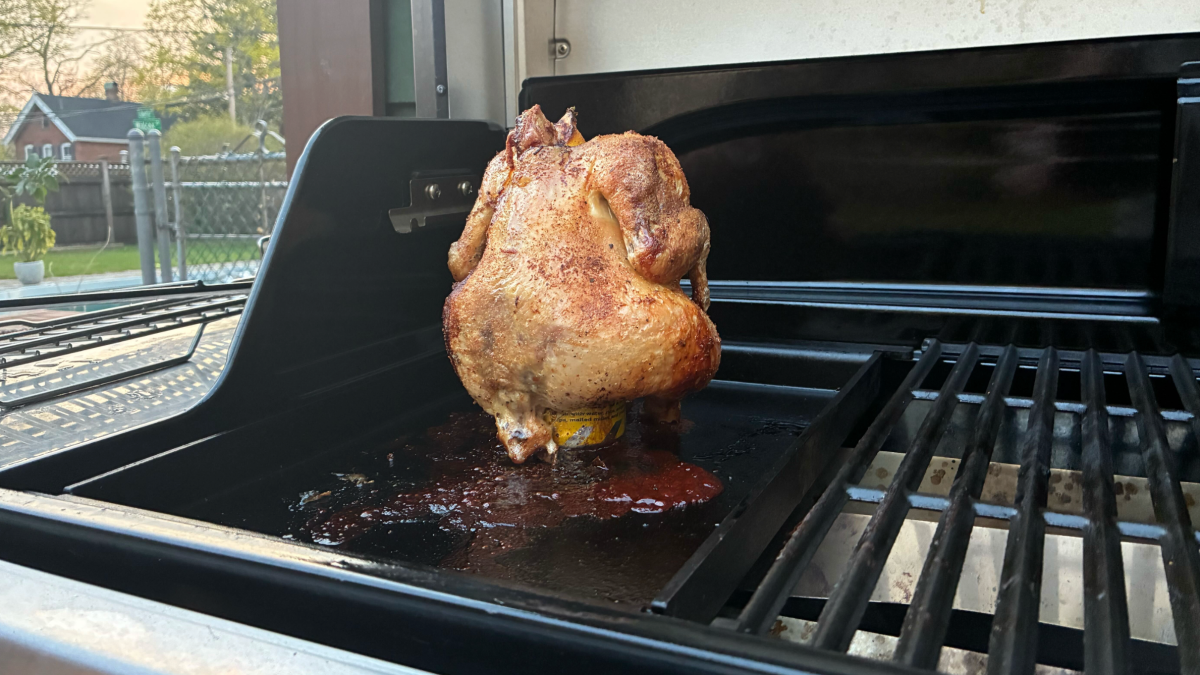 chicken cooking on griddle with grease pouring out