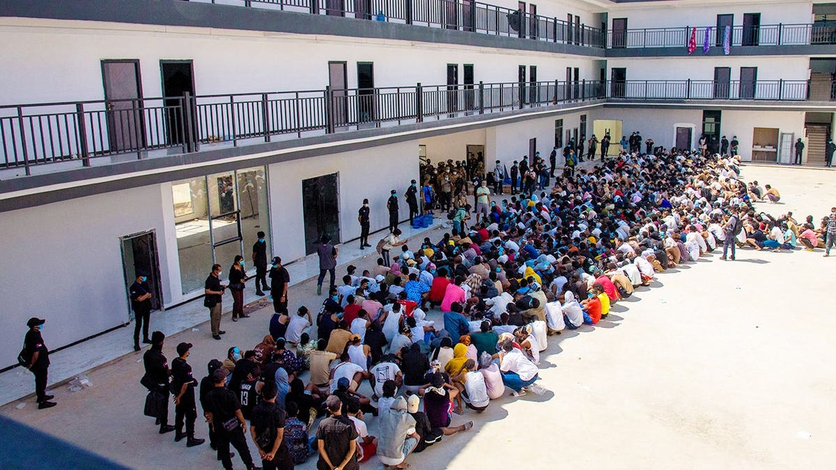 Scam center victims wait in a compound in Myanmar