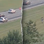 Ohio man fleeing police on foot leaps onto moving car, tries to take control before falling off: Police