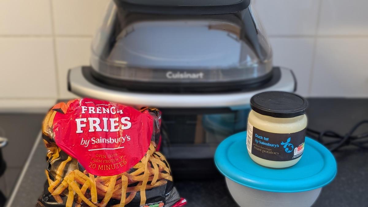 air fryer with bagged fries bowl and duck fat in front