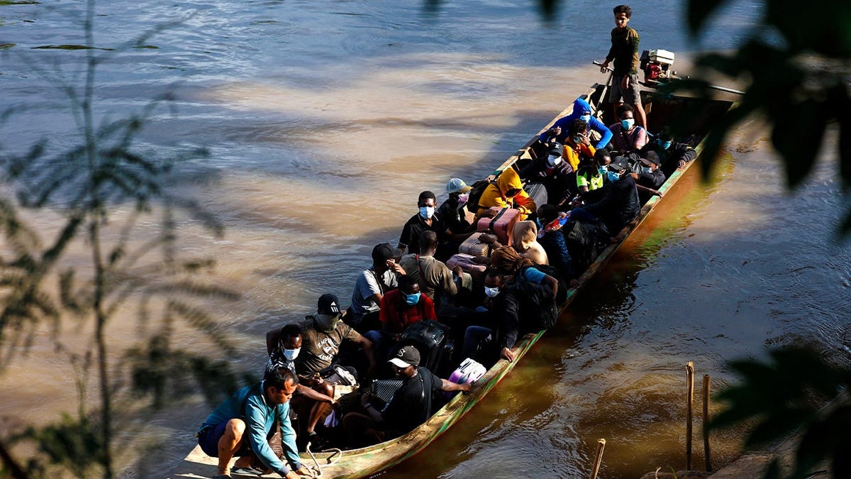 People from various countries, who were working in the KK Park compound in Myanmar, travel in a boat across the Moei river to cross over from Myanmar to Thailand, as seen from Mae Sot District, Tak Province area on October 24, 2025.