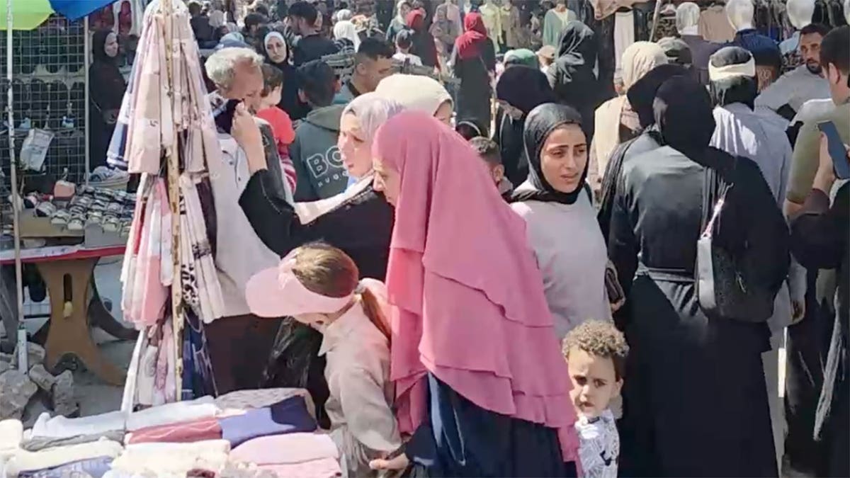 Palestinians shop at a crowded Eid al-Adha market in Gaza