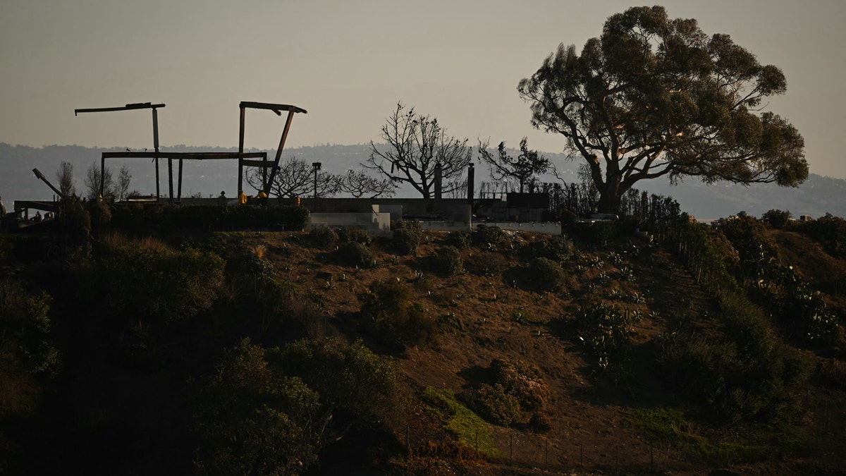 A charred remain of a home destroyed by the Palisades Fire isseen in the Pacific Palisades neighborhood of Los Angeles, California, on January 13, 2025. Firefighters were battling massive wildfires on January 13 that have ravaged Los Angeles and killed at least 24 people, with officials warning of incoming dangerous winds that could whip up the blazes further. (Photo by Patrick T. Fallon / AFP) (Photo by PATRICK T. FALLON/AFP via Getty Images)