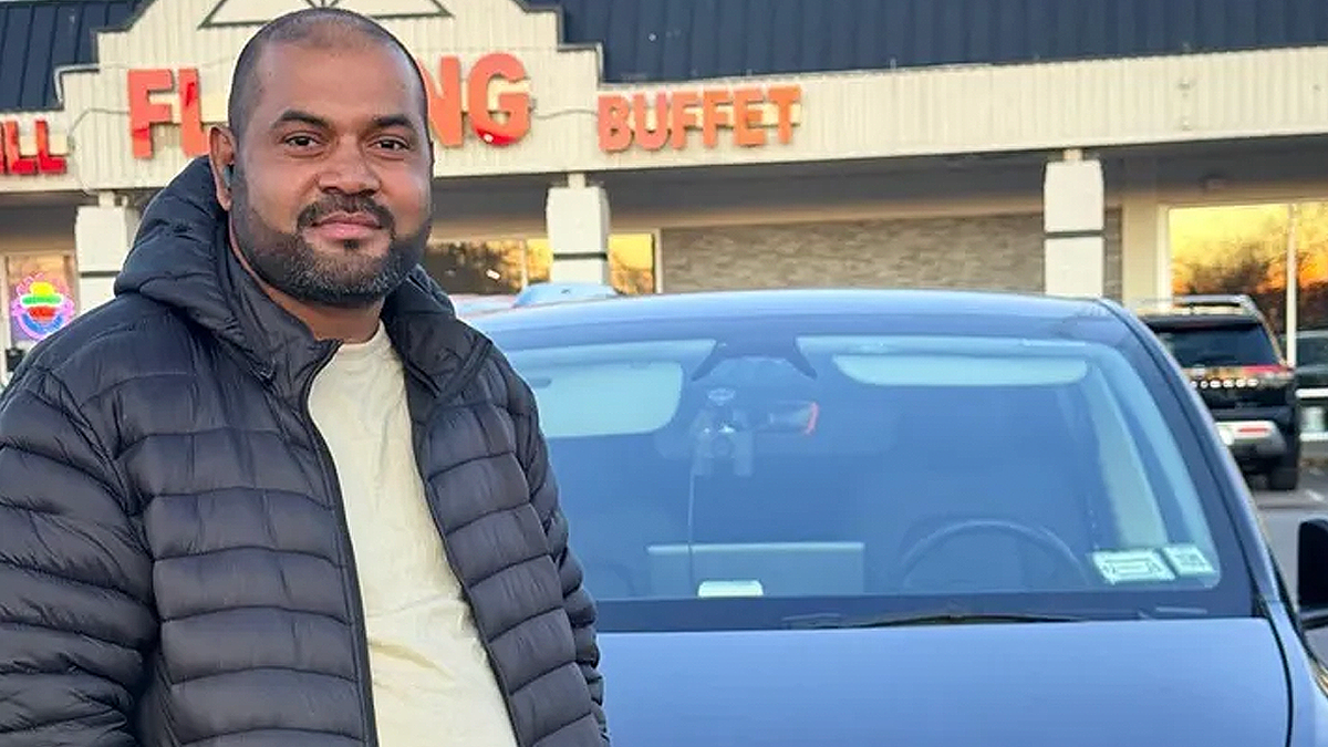 MD Yousuf stands in front of a restaurant in a family-provided photo
