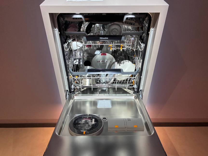 miele dishwasher open with dishes inside