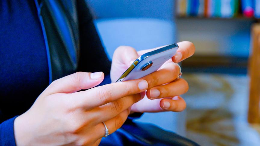 Close-up of a person using an iPhone Air, which has a familiar, flat form.
