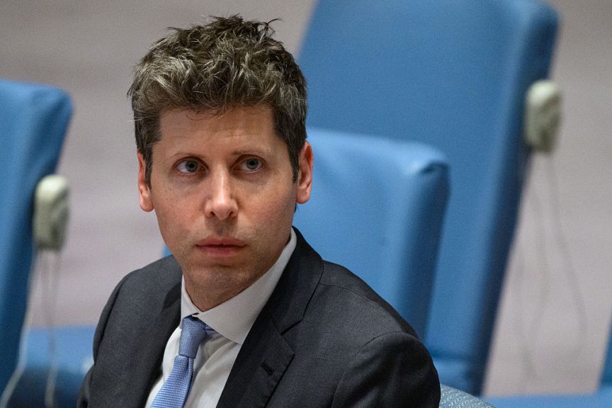 OpenAI CEO Sam Altman sits at the United Nations Security Council. He looks at the camera and there's a sort of menacing affect to him.