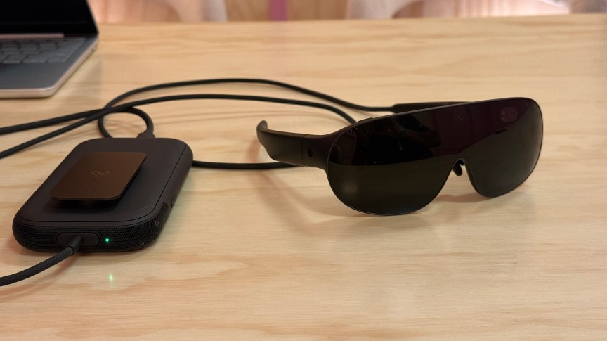 Meta VR Glasses attached to a black processor puck on a table