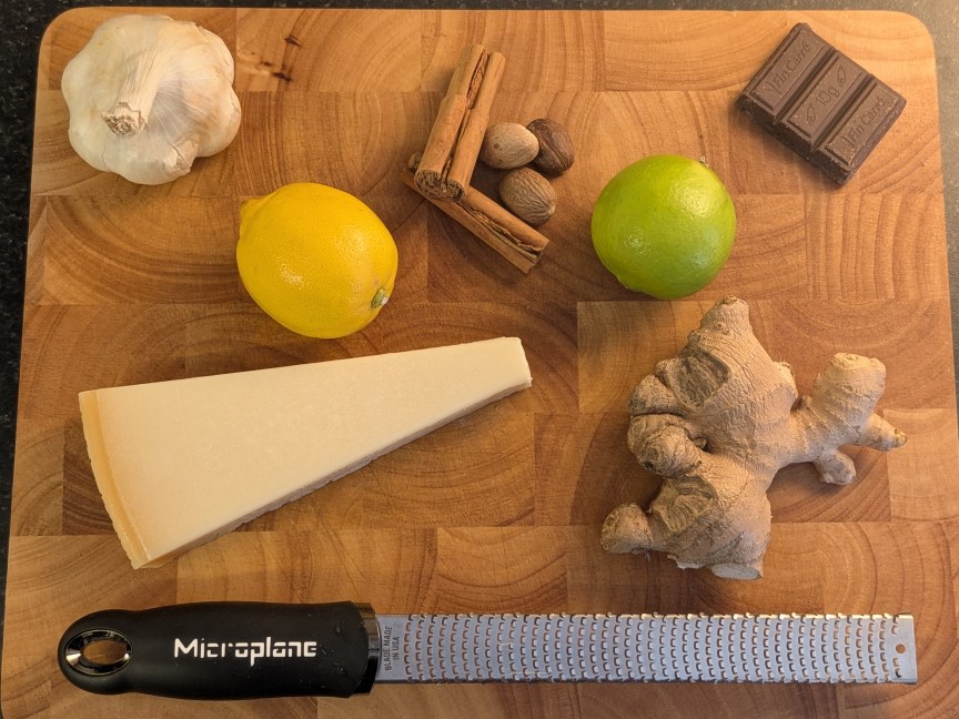 Microplane on board with ginger lemons garlic and other ingredients