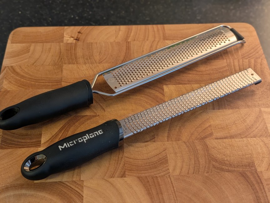two different microplanes  resting on cutting board