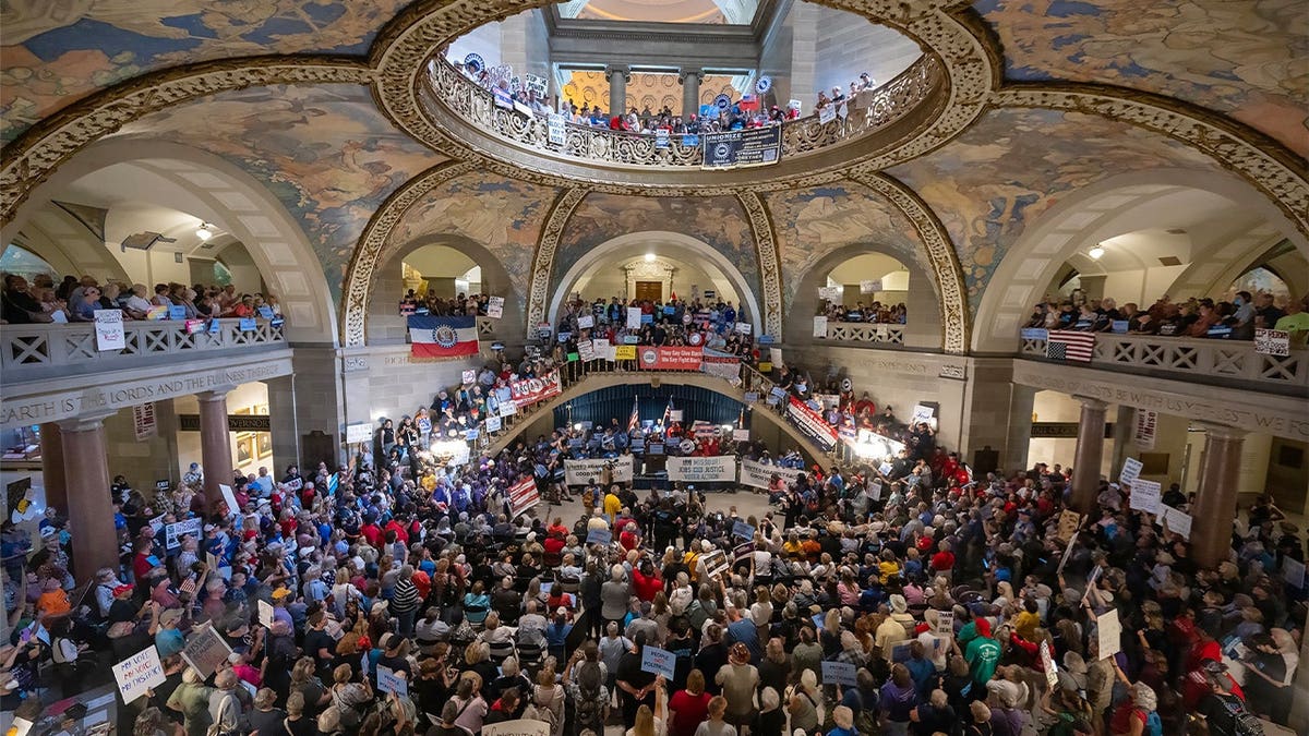 People gather at the Missouri statehouse in Jefferson City on Wednesday, Sept. 10, 2025, to protest the legislature's efforts to change the state's congressional district maps. The proposed change would divide Kansas City into districts that would include vast rural areas of the state.