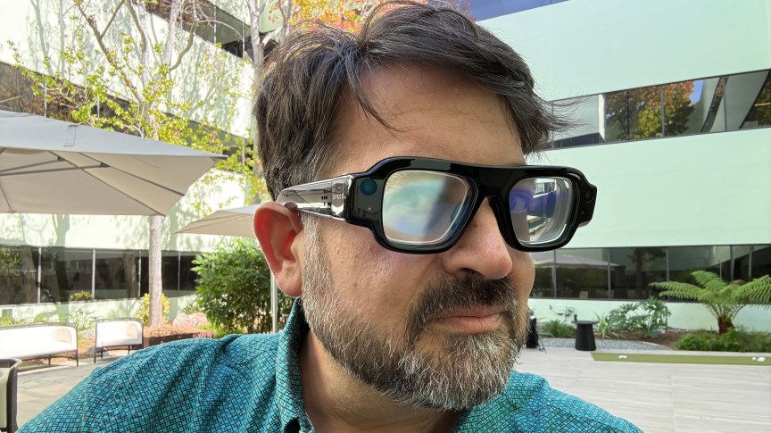 Scott Stein wearing large black AR glasses from Snap called Specs
