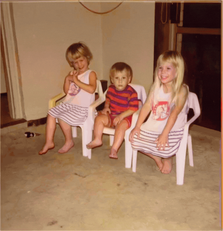 A gif showing a still photo of three children animated by AI