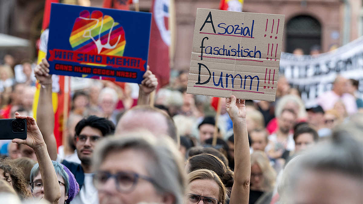Protesters holding a sign that read 