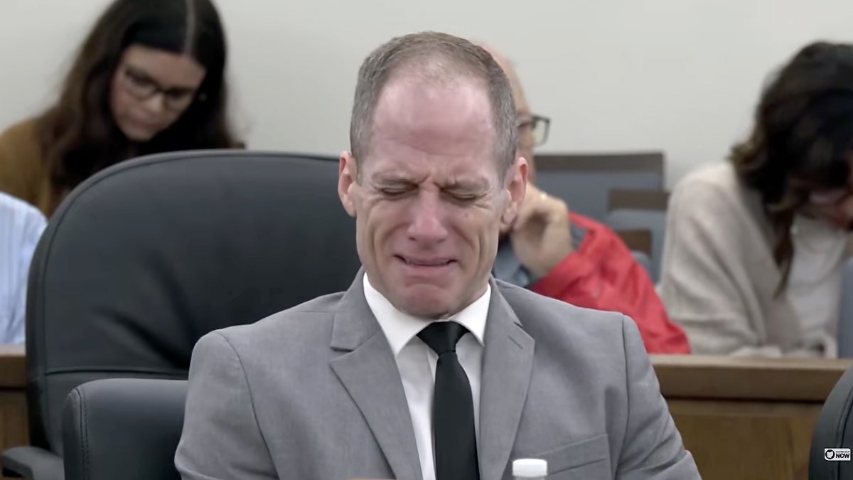 Caleb Flynn sits in an Ohio courtroom with tears on his face during his murder trial in the February 2026 shooting death of his wife, Ashley Flynn.