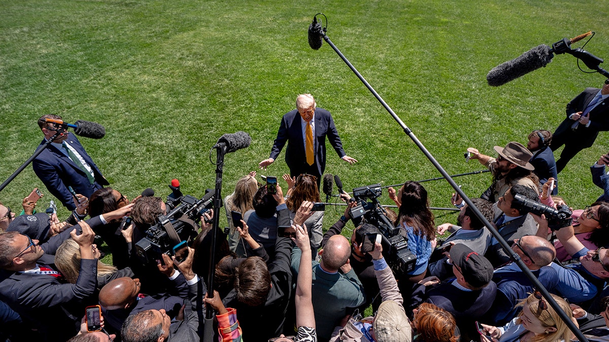 Donald Trump with reporters before traveling to Beijing, China.