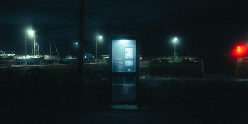 An image of a phone box at night.