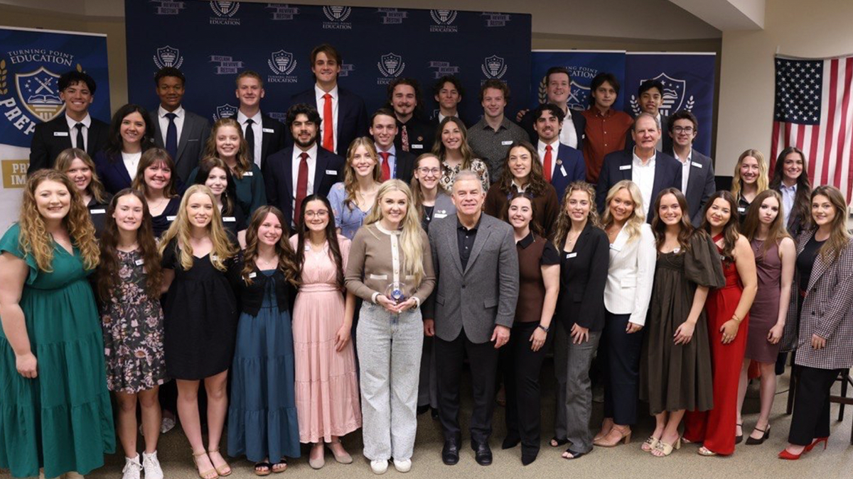 Students and staff pose for a group photo at a Turning Point Education event.